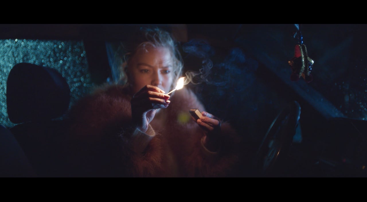 A woman lights a match in Running Out